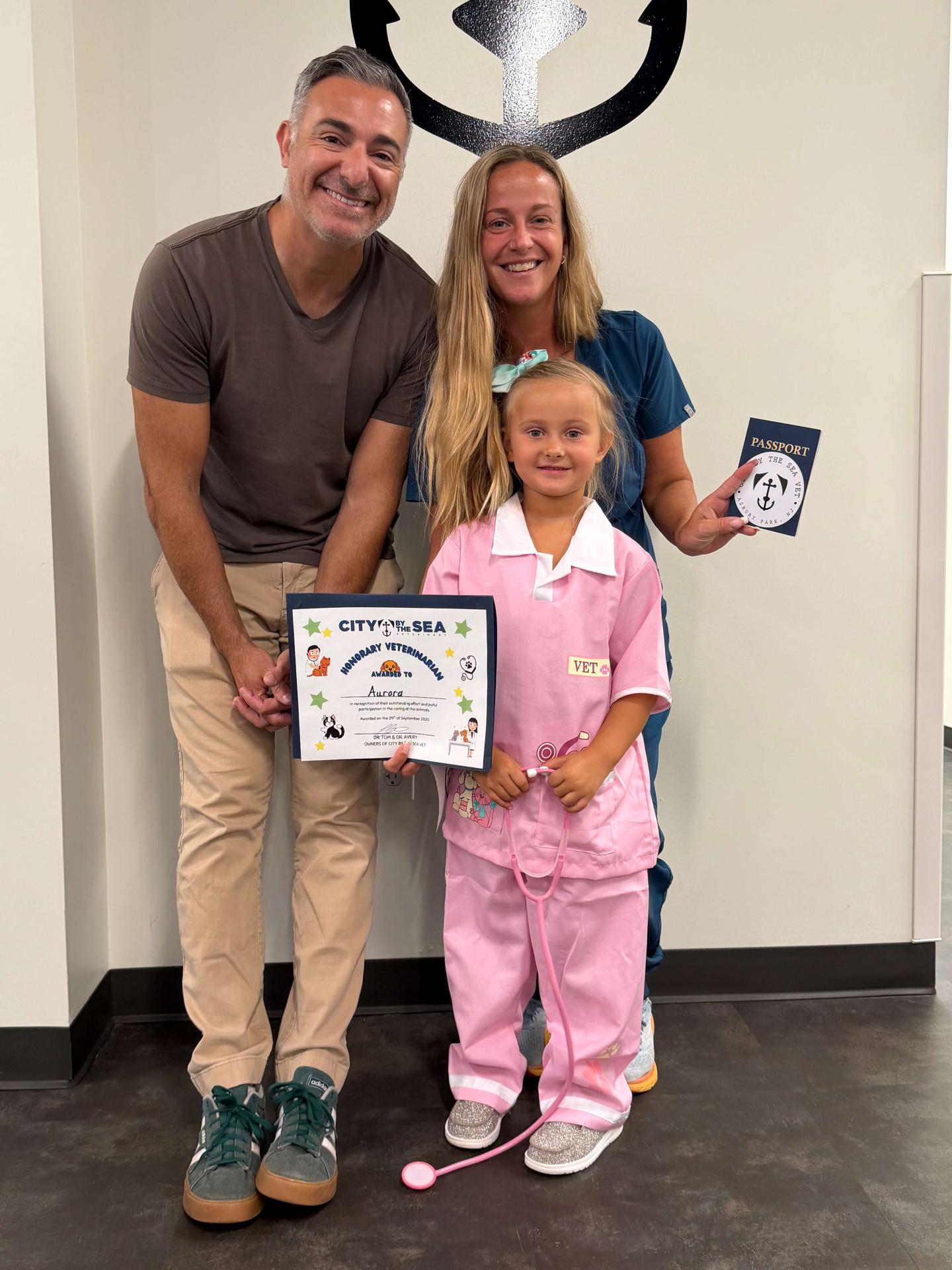 Children posing with their degrees